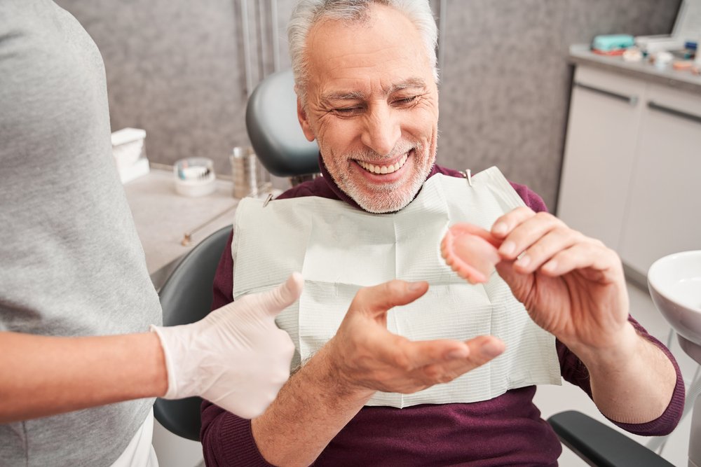 My,New,Teeth.,Cropped,View,Of,The,Dentist,Showing,To How Dentures Can Improve Your Quality of Life